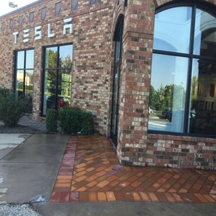 sidewalk in front of a commercial building that has been pressure washed